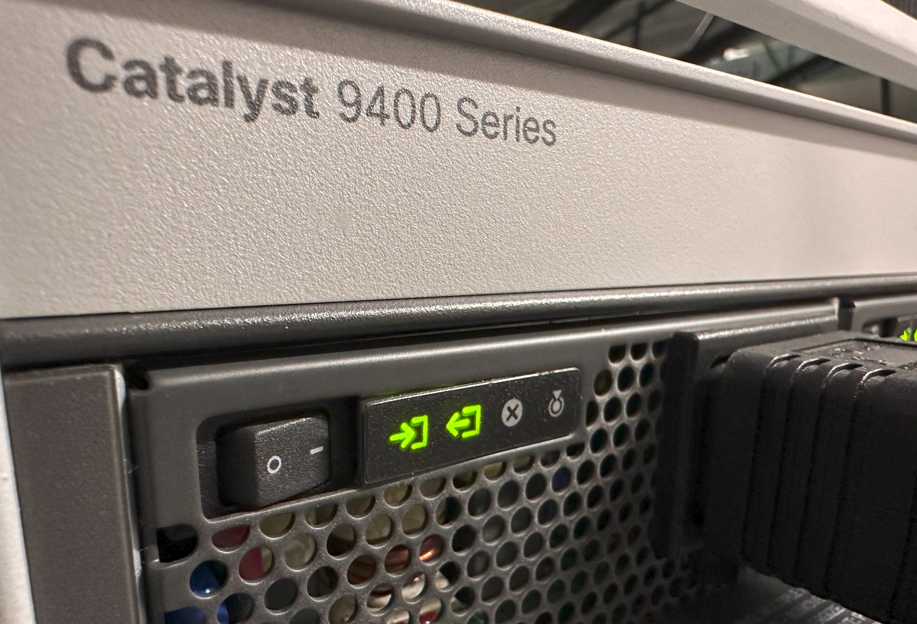 Close-up of network switch ports with connected cables and blinking LED lights